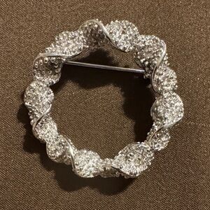This is a vintage Emmons silver-tone twisted wreath brooch pin